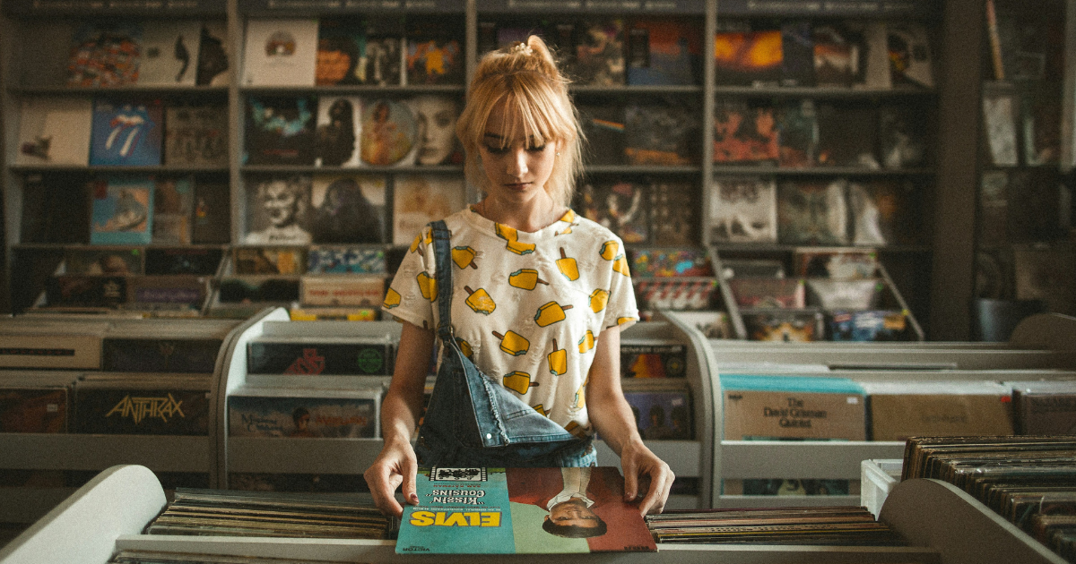 Woman flipping through records in a record shop