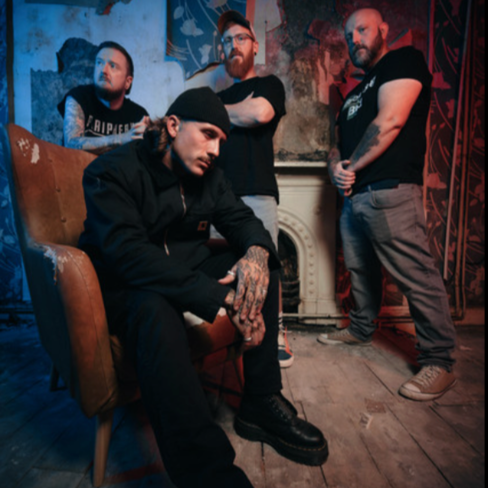 Edit the Tide, a four-piece, posing in a dim room with a fireplace