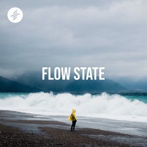 Cover for the Flow State playlist - a figure in a yellow coat on a stormy beach