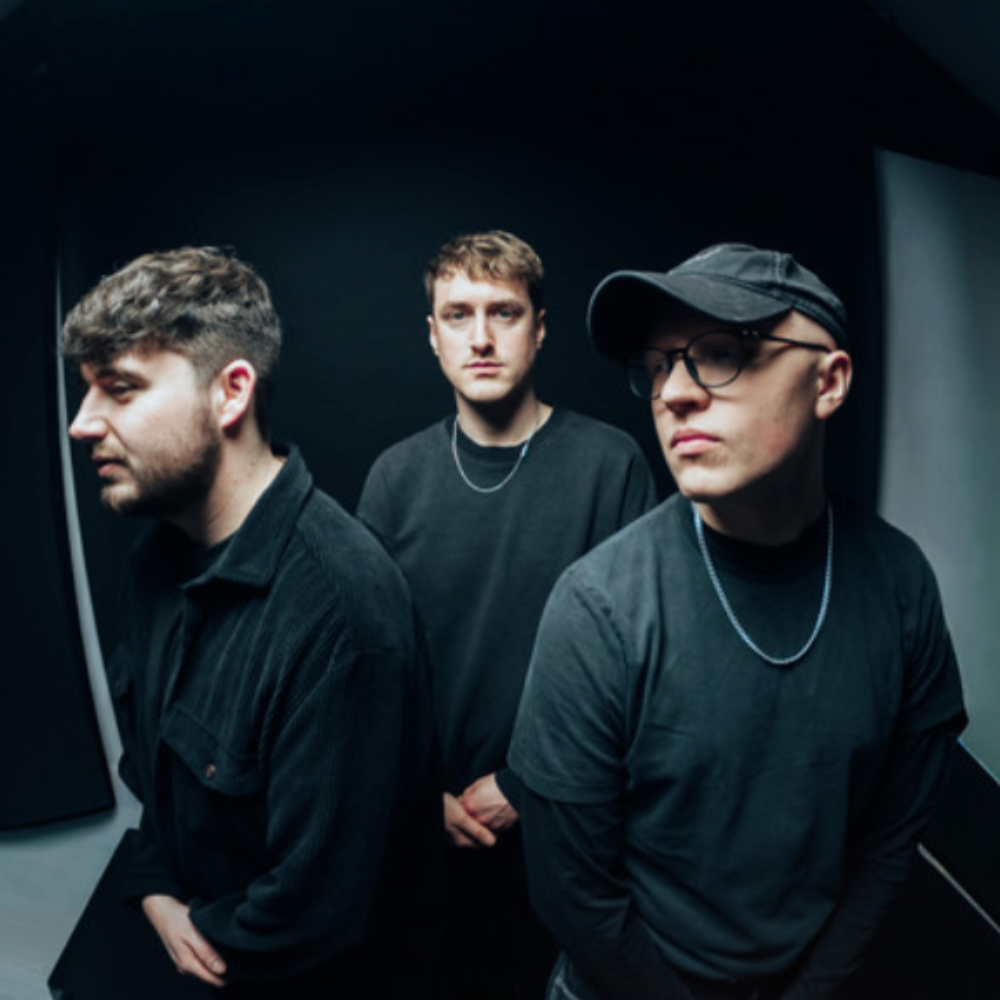 Teminals, a three-piece in black, against a dark backdrop