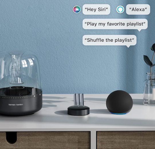 WiiM Mini streamer on a shelf next to smart speakers, with Siri and Alexa voice commands shown