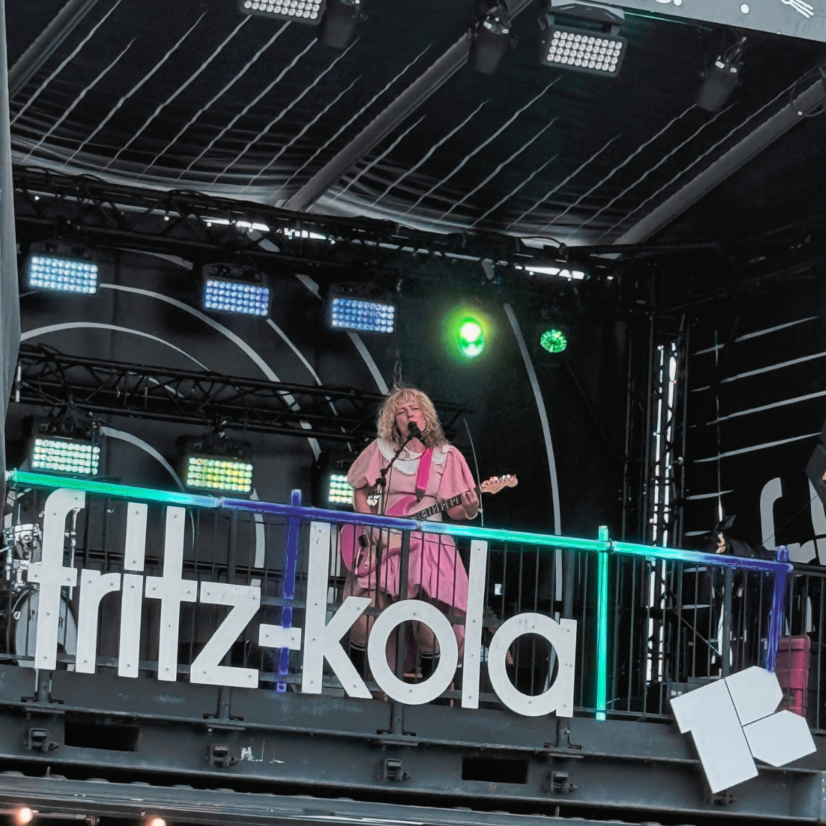 A Mess playing guitar and singing on the fritz-kola stage at Reeperbahn Festival