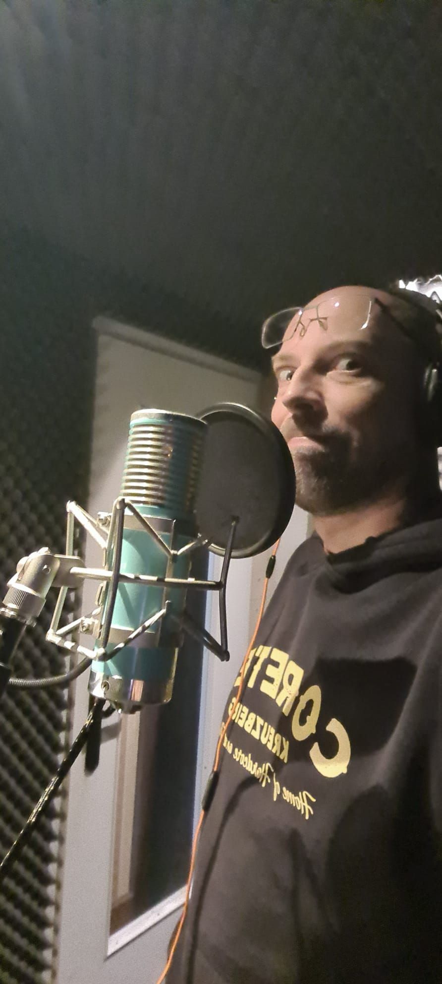 Toifel at a studio microphone in headphones