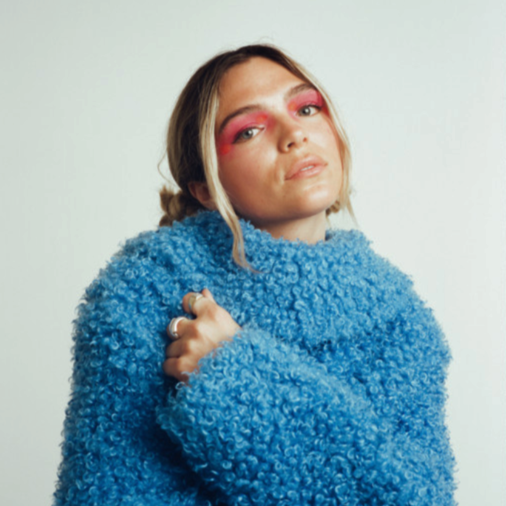 Emma in a fluffy blue jumper with pink eye make-up