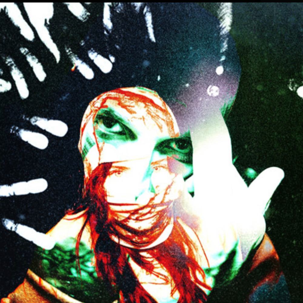 Distorted green and red portrait of a red-haired artist behind white handprints, from the trip-hop pick