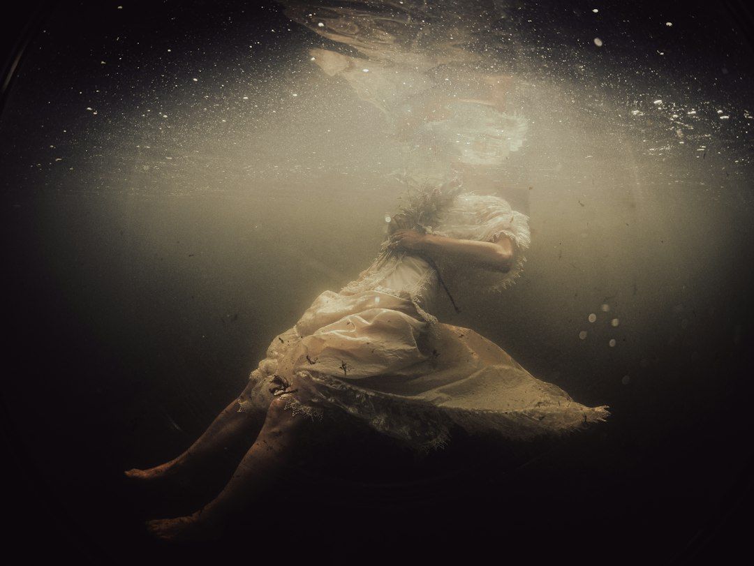 Underwater shot of a bride floating in clear mountain water. Part of music video for Welsh artist Unity.