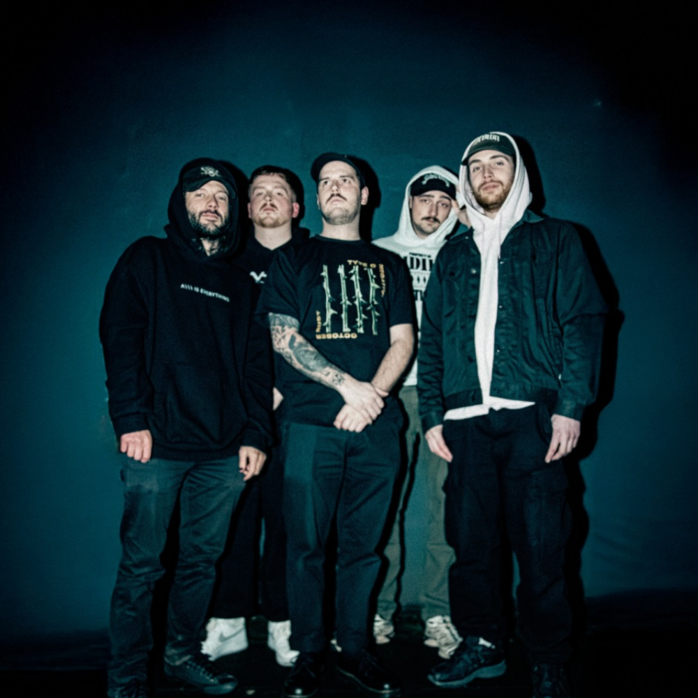 The Aberdeen-based metal band, five members in dark hoodies against a black backdrop