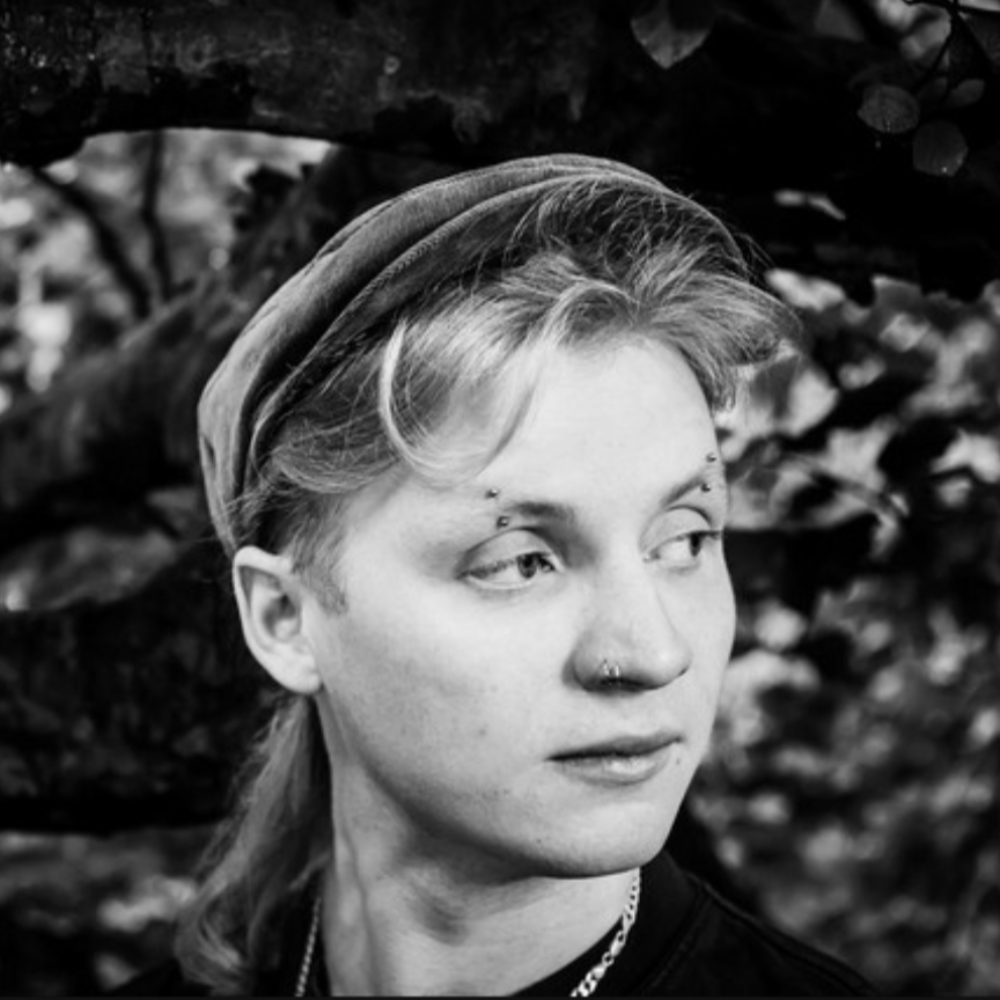 Black and white portrait of Charlie Power in a flat cap