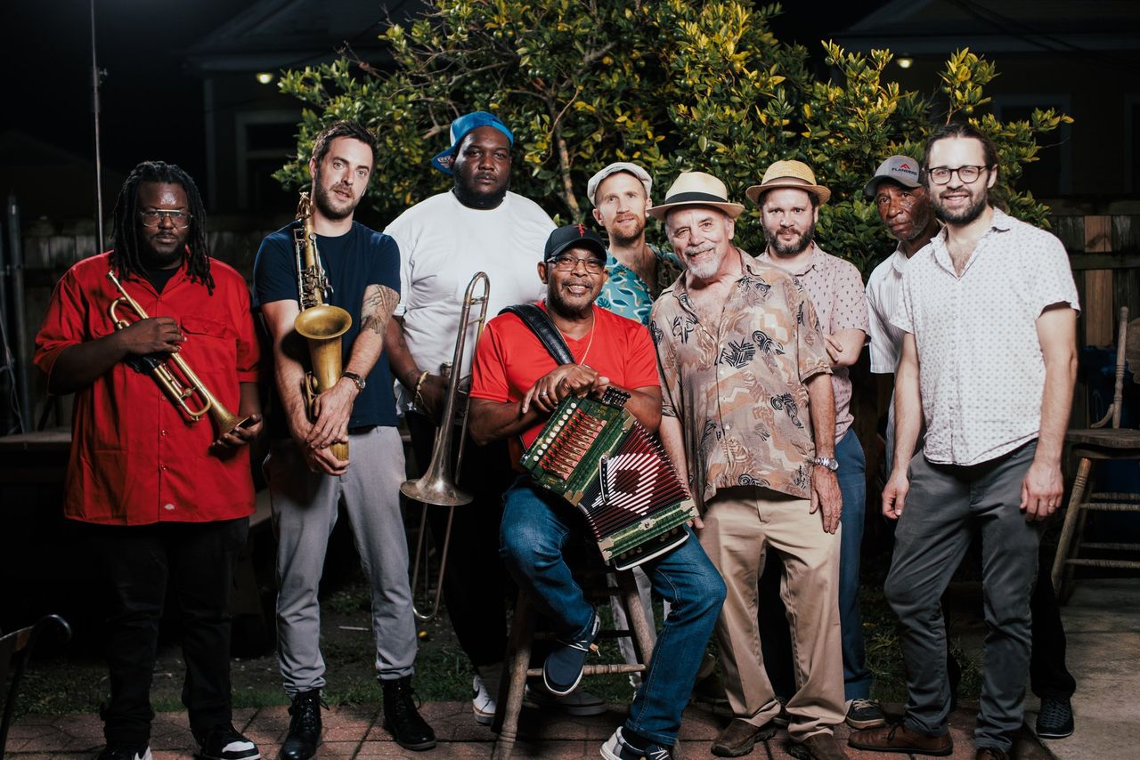 Jeffery Broussard & The Nighttime Syndicate posing with accordion, trumpet, sax and trombone