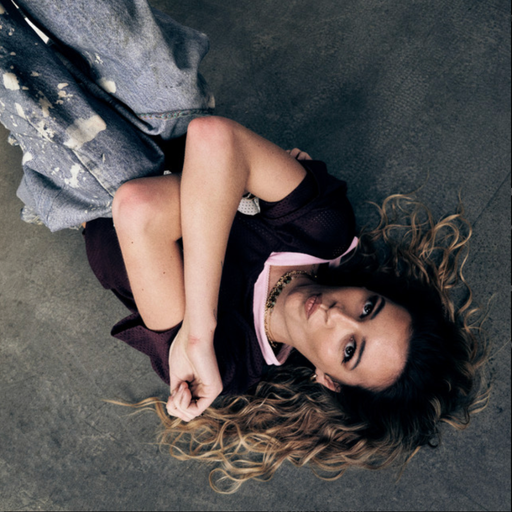 Jos Rivers lying on a concrete floor looking up at the camera