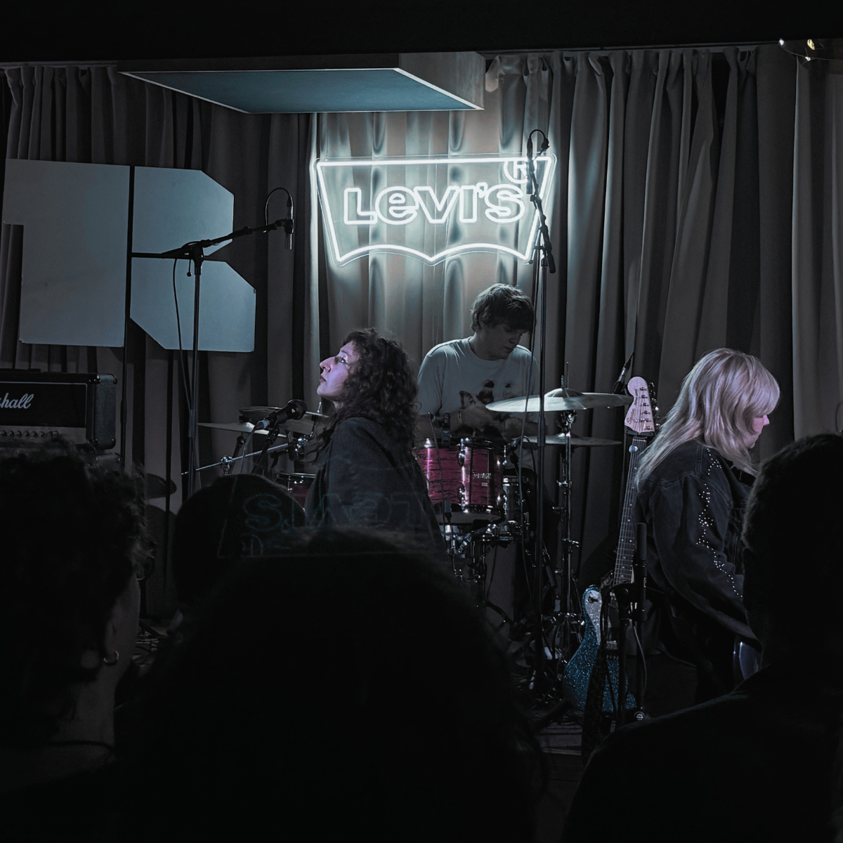 Maia and the Squires playing a small Levi's-branded stage to a dark crowd