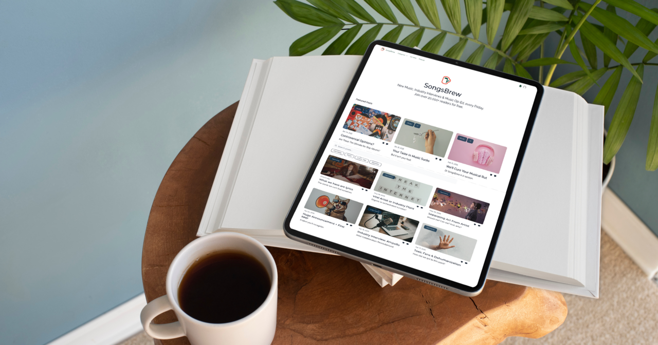 Tablet showing the SongsBrew website, next to a cup of coffee
