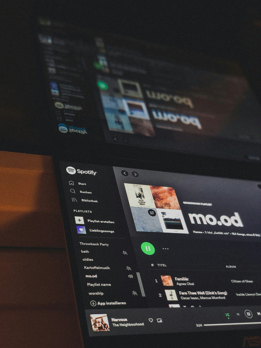 Laptop screen showing a Spotify playlist in dark mode
