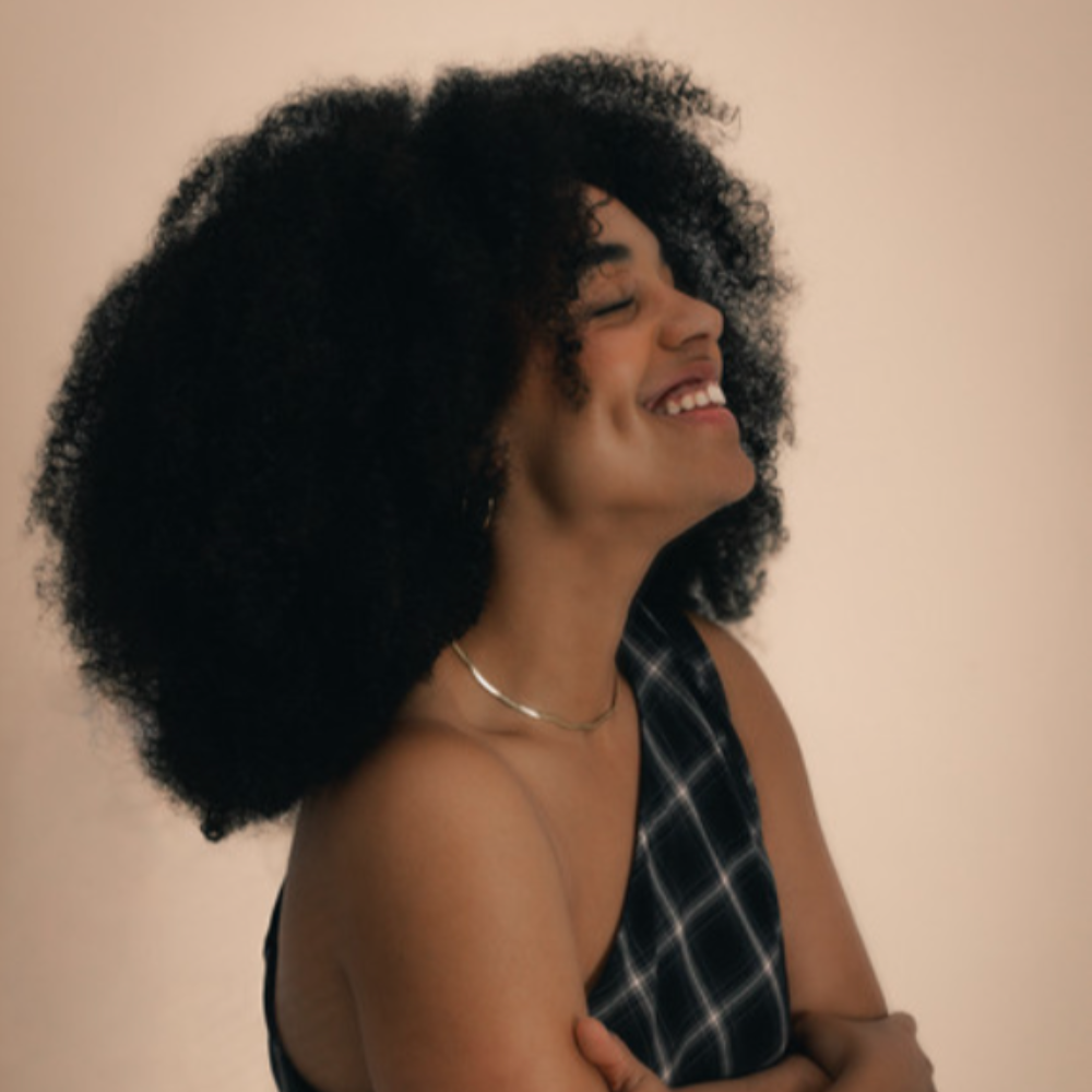 Robine smiling with her eyes closed and head tilted back