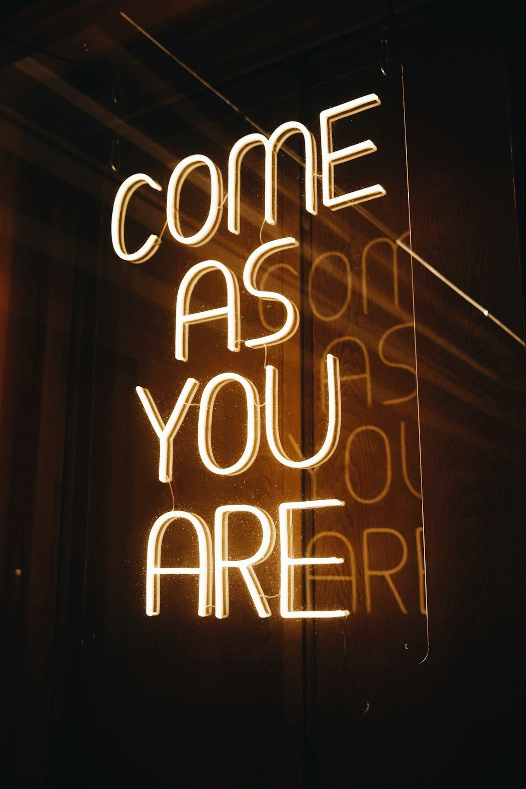 Neon sign reading COME AS YOU ARE