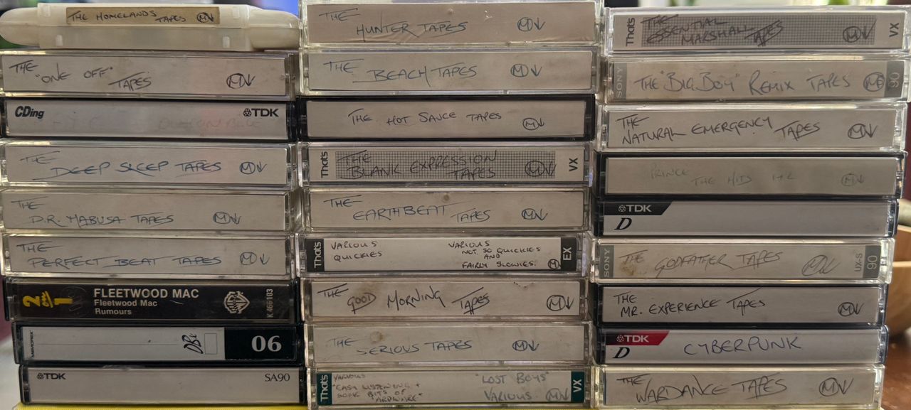 Stacks of handwritten mixtape cassettes, with a Fleetwood Mac Rumours tape among them