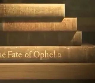 Blurry AI video still of stacked books, the spine reading 'The Fate of Ophela'