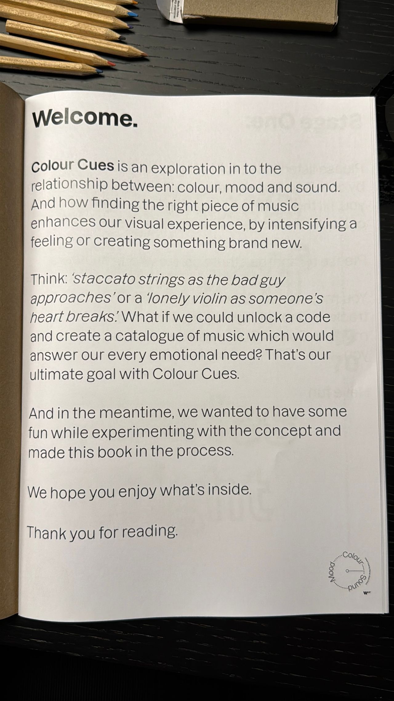 Colour Cues booklet welcome page, explaining the project on colour, mood and sound, beside coloured pencils