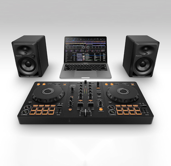 Pioneer DJ DDJ-FLX4 controller in front of a laptop and two monitor speakers