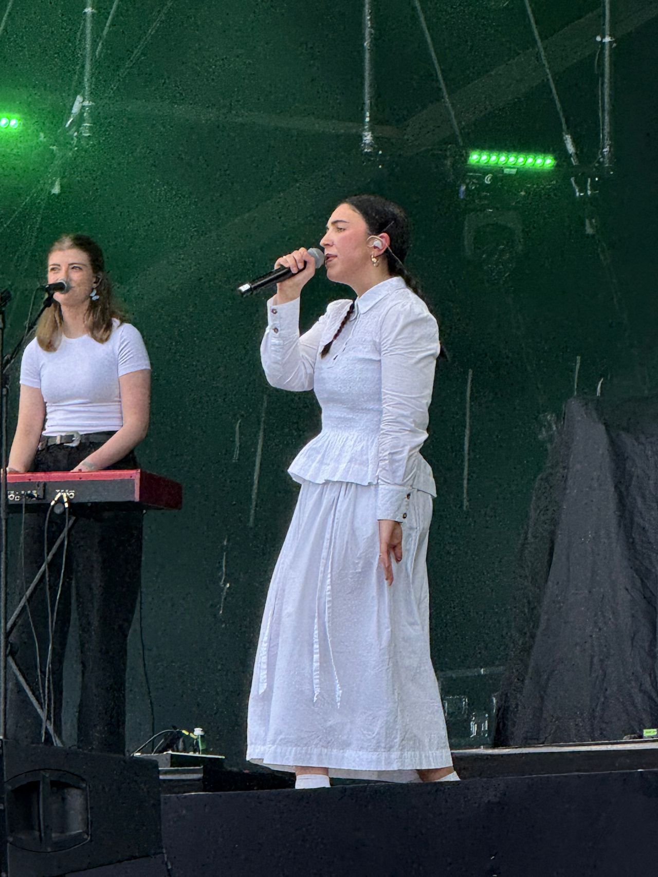 Morgana singing on stage with a keyboard player beside her